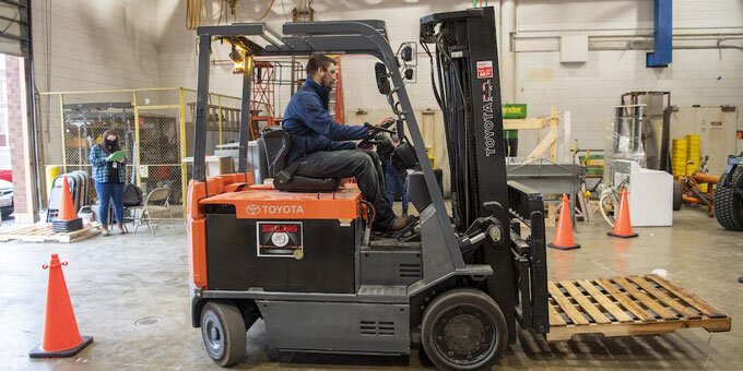 Staff member driving forklift