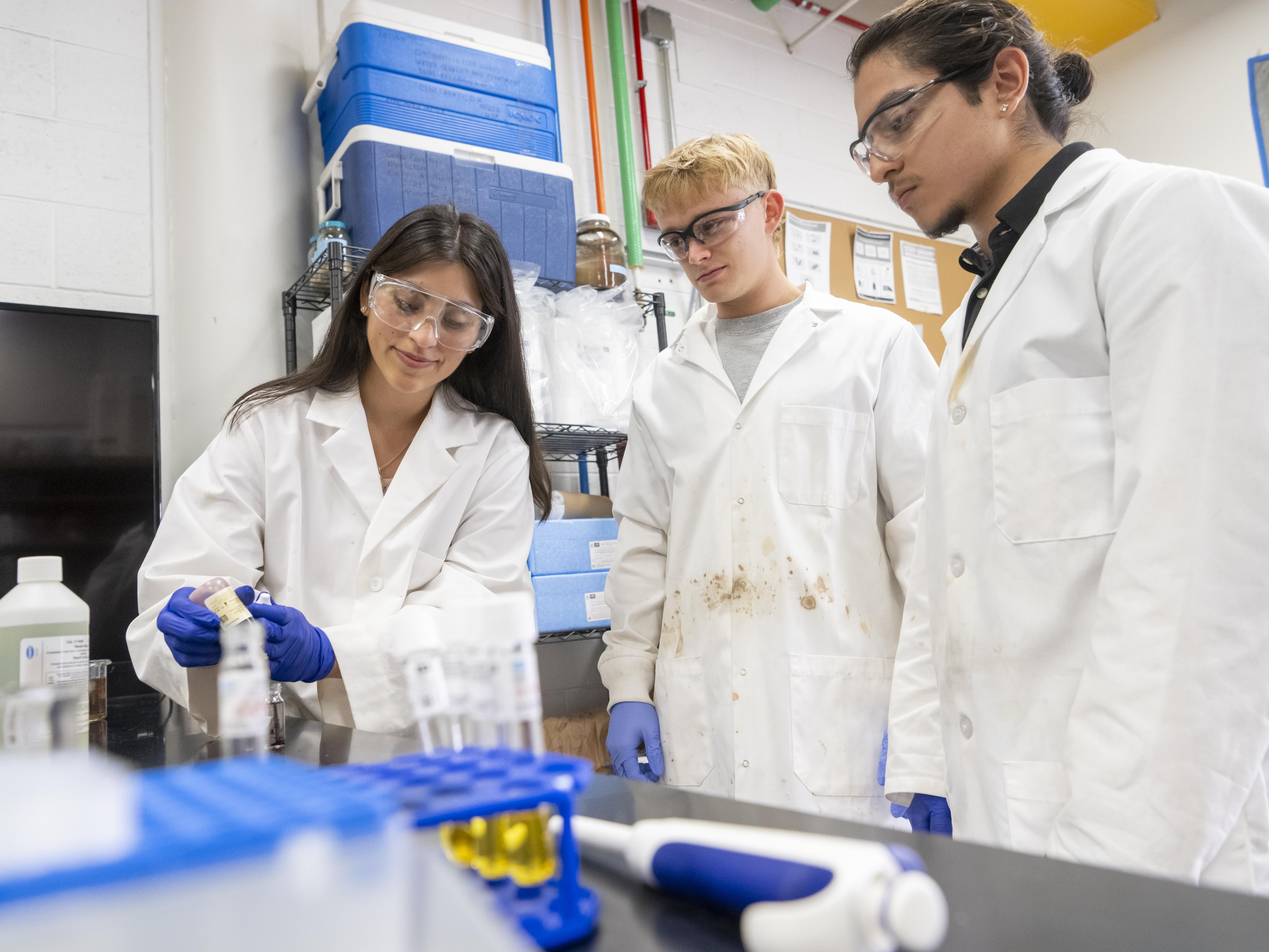 Three researchers in lab coats.