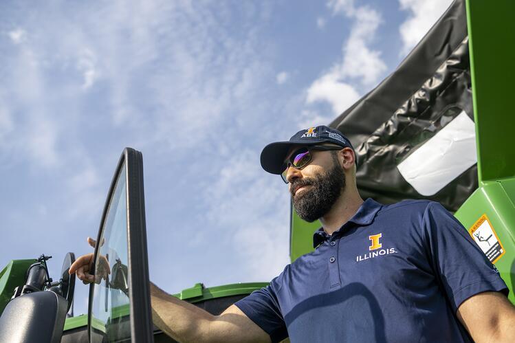 ABE worker standing in front of a tractor
