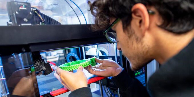 Student working with a 3D printer