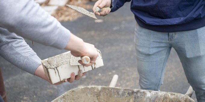 Students learning masonry