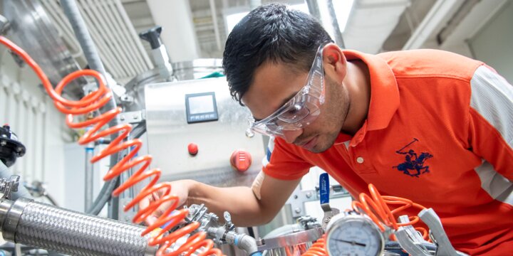 Student running machinery at IBRL.