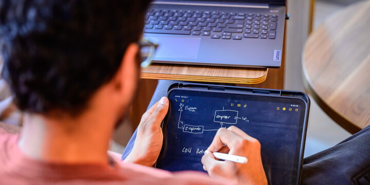 A student taking notes on an iPad