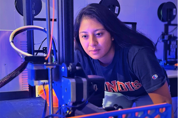 Woman looking at 3D printer